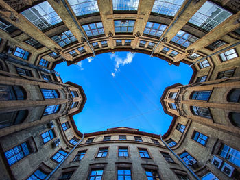 Low angle view of buildings against blue sky