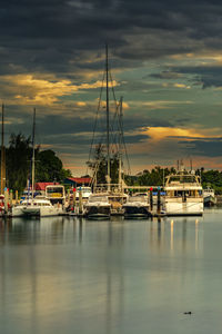 Boats in marina at sunset