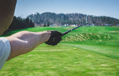 Cropped image of man holding golf club