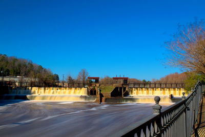Scenic view of bridge against clear blue sky