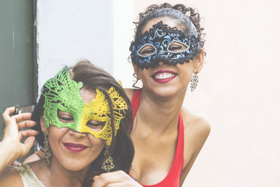 Portrait of two women wearing venice carnival mask. 