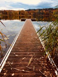 Pier over lake against sky