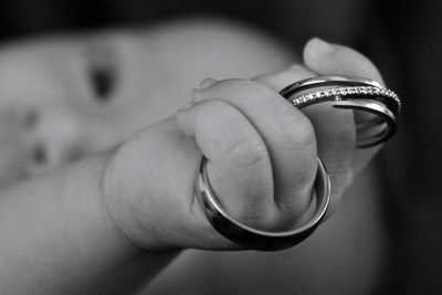 Cropped hand of child holding bangles