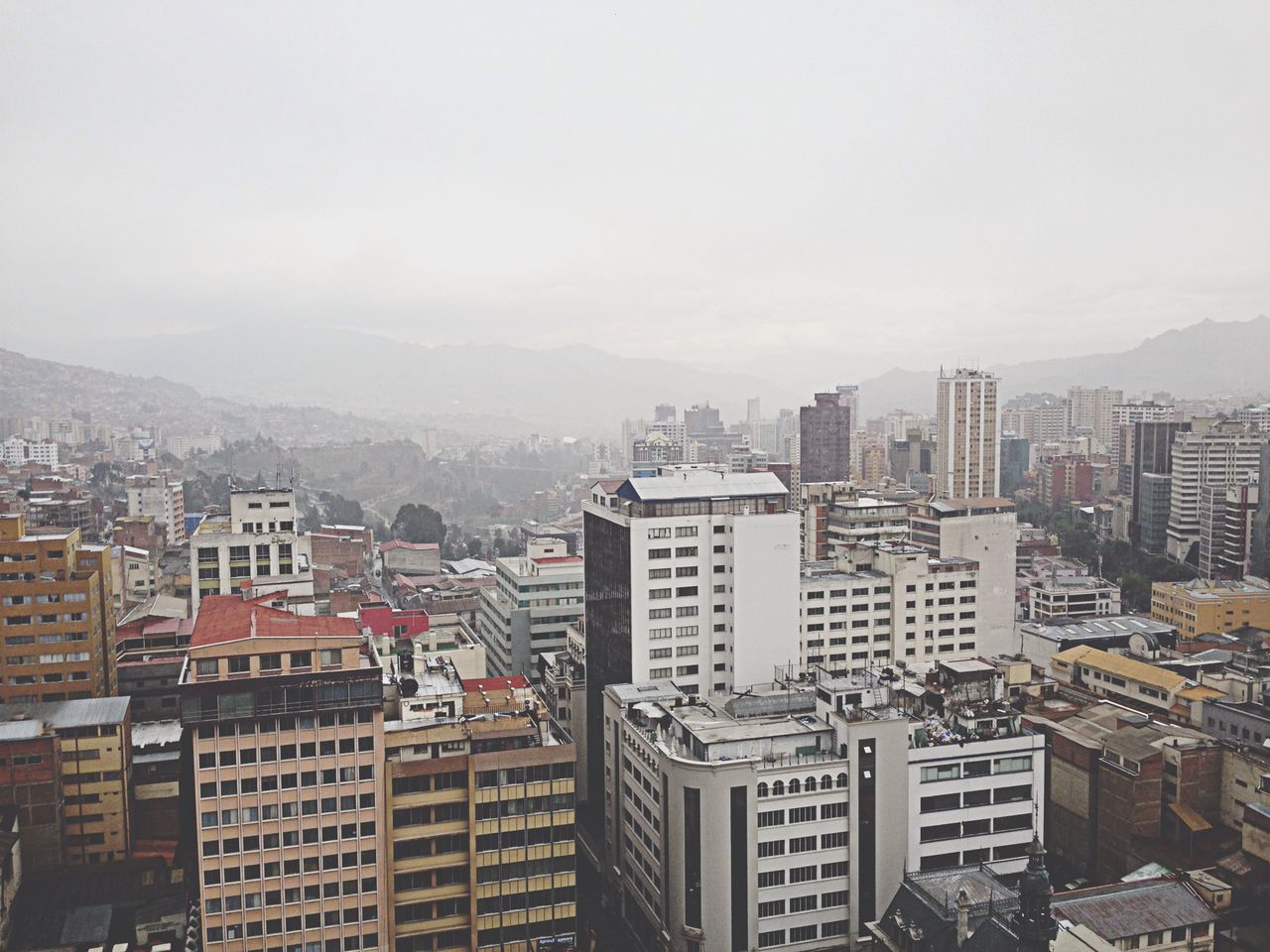 building exterior, architecture, built structure, city, cityscape, mountain, residential district, crowded, residential building, residential structure, high angle view, sky, mountain range, copy space, day, clear sky, outdoors, no people, city life