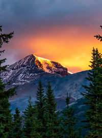 Scenic view of snowcapped mountains against sky during sunset