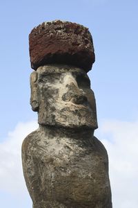 Low angle view of stack of statue against sky