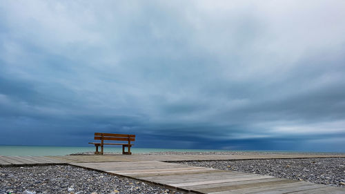 Lifeguard hut on beach against sky