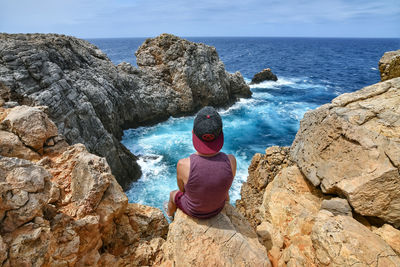 Rear view of man looking at sea shore