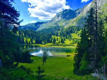 Scenic view of lake and mountains against sky