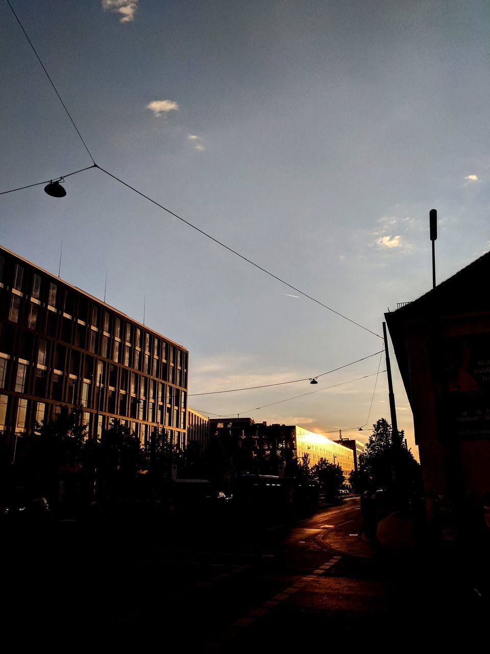 CITY STREET AGAINST SKY DURING SUNSET