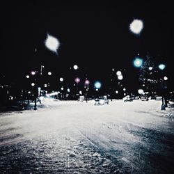 Snow covered road at night