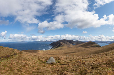 Scenic view of sea and mountains against sky