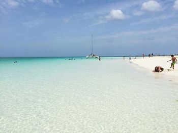 View of calm beach against blue sky