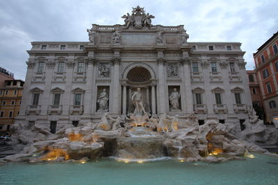 View of fountain in city against sky