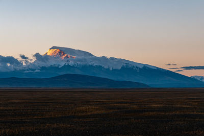 Scenic view of volcanic landscape against sky during sunset