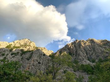 Low angle view of rocks against sky