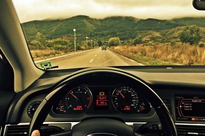 Cars moving on road seen through car windshield