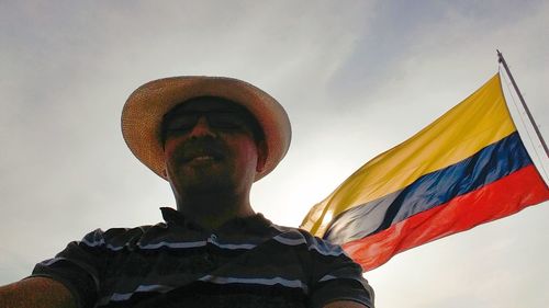 Low angle view of man standing against sky