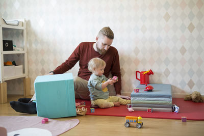 Portrait of boy playing with toy at home