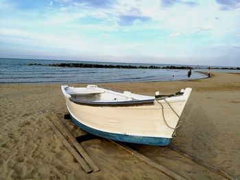 Boat moored on sandy beach