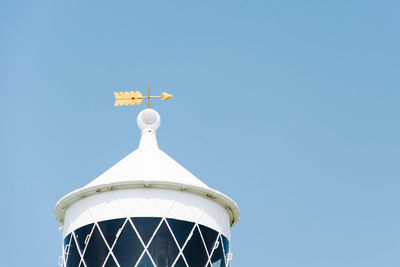 Low angle view of weather vane on tower