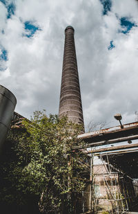 Low angle view of buildings against cloudy sky