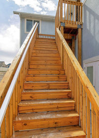 Low angle view of staircase by building against sky