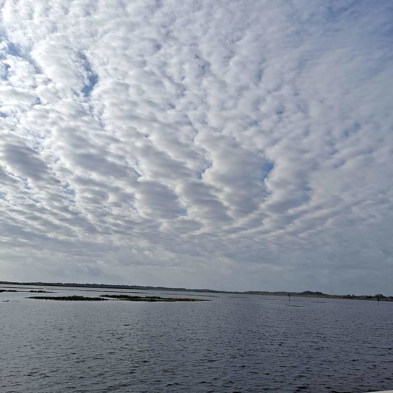 sky, water, cloud, horizon, scenics - nature, sea, beauty in nature, nature, tranquility, tranquil scene, ocean, no people, day, environment, shore, outdoors, reflection, idyllic, blue, coast, beach, landscape, land, non-urban scene, horizon over water