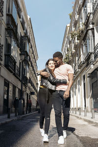 Couple walking on road in city