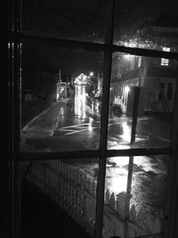 City street seen through window at night