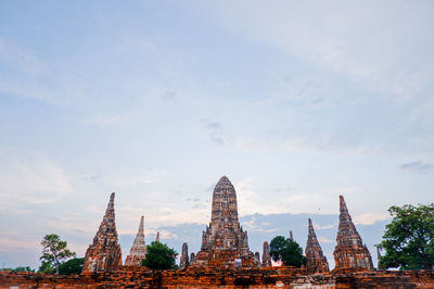 Old pagoda and buddha statue in the evening archaeological site, phra nakhon si ayutthaya, thailand.