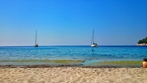 Scenic view of sea against clear blue sky