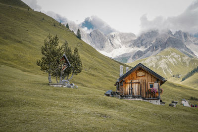 House on mountain against sky