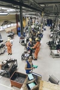 Male and female coworkers working in industry warehouse