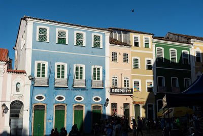 Group of people in building against sky in city