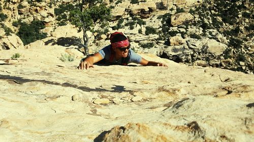 Full length of woman standing on rock