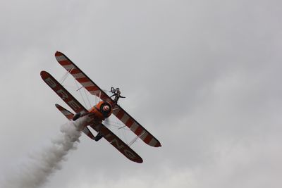 Low angle view of airplane flying in sky