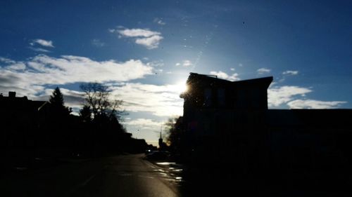 Empty road against cloudy sky