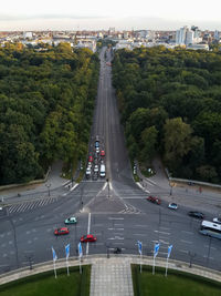 High angle view of cars on street amidst trees against sky