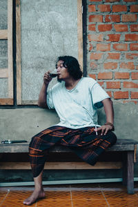 Young woman sitting on bench