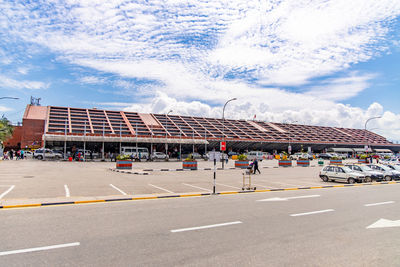 Road by building against sky