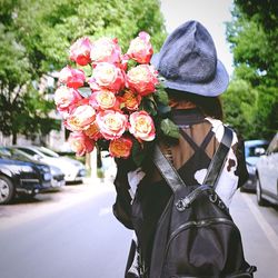 Close-up of woman with red roses in car