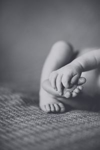 Cropped image on baby on rug