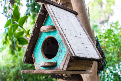 Close-up of birdhouse on tree trunk