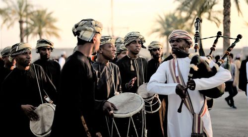 Musicians in traditional clothing performing on street