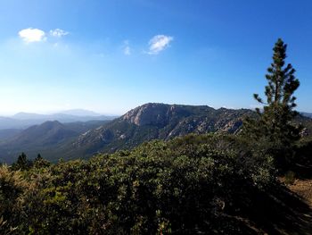 Scenic view of mountains against blue sky