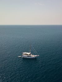 Sailboat sailing on sea against sky