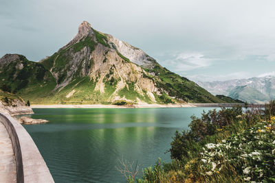 Scenic view of lake and mountains against sky