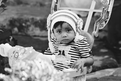 Portrait of cute girl sitting in baby stroller