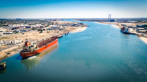 High angle view of port docks against blue sky